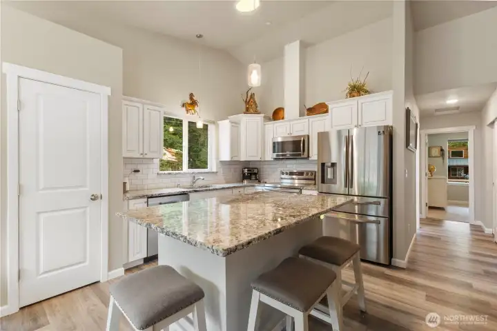 Bright kitchen. Pantry storage at left.