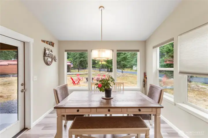 Tons of windows make the dining, kitchen and living area bright.  Plenty of room around the table to gather friends.