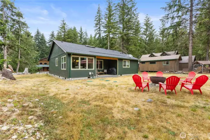 Dining room door leads out to a covered back patio. A great place to hang out rain or shine (or snow)!  11,250 SF lot with room to play. (Metal fire ring liner does not convey).