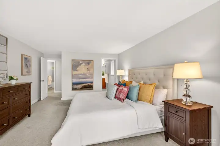 The primary suite is a true retreat, offering generous space, a calm color palette, and an easy connection to the private bath and walk in closet.