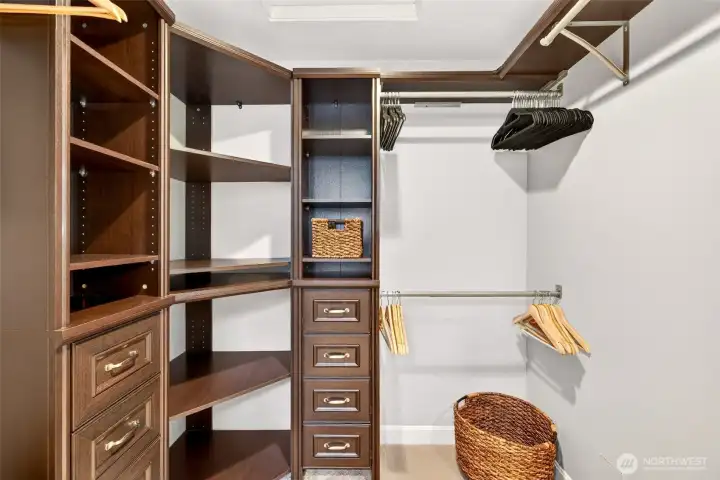 A renovated walk in closet delivers excellent organization with custom shelving, drawers, and hanging space, designed to keep daily routines streamlined.