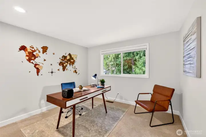 A versatile upstairs bedroom offers comfortable proportions and a peaceful view, ideal for a dedicated work from home setup, guests, or hobbies.