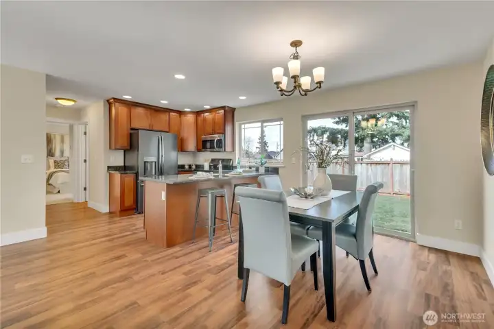 Dining space & kitchen with breakfast bar!  Down hall is bedroom. 3/4 bath located through doorway between kitchen & bedroom..