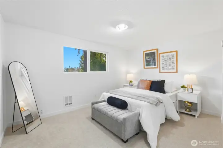 The main bathroom has been tastefully refreshed to reflect a more modern aesthetic. A new vanity provides both style and practical storage. The updated mirror enhances the space, adding a clean and polished look.