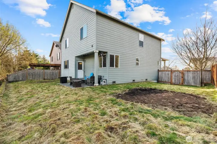 Large partially fenced backyard
