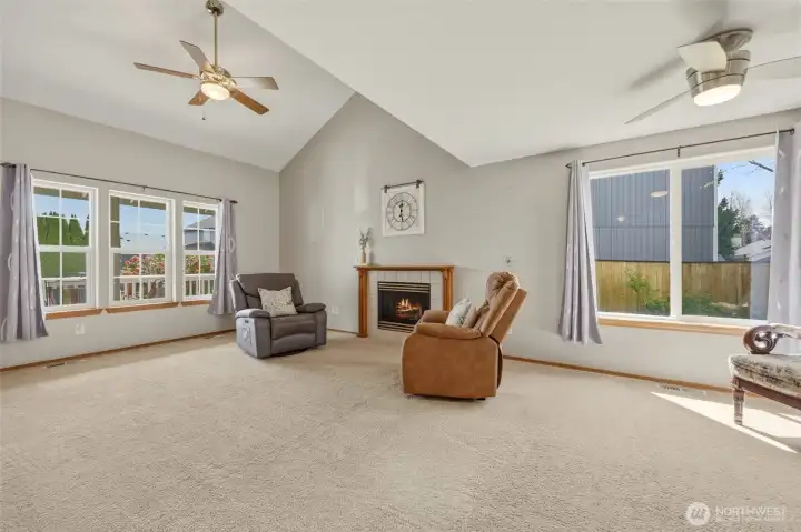 Living room offers wall of windows and ceiling fan. The optional dining room is seen here as well.