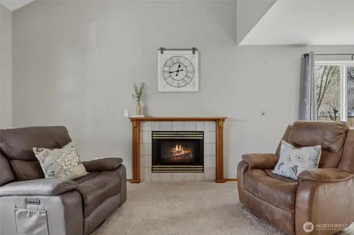 The Fireplace as focal point is easy-use gas with warm wood mantle and tile surround, adding simple comfort to this lovely front room.