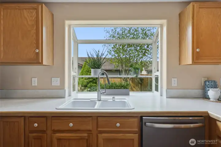 Charming garden window allows in ample natural light--ideal for growing things that make you happy... flowers, plants, or herbs?