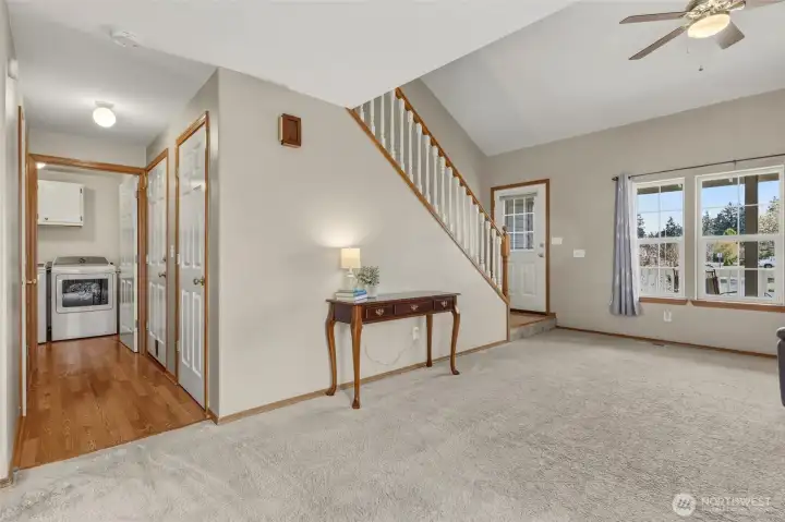 Off the front living room is this hallway to the garage, which also conveniently offers a hall closet, 1/2 bath, and laundry room...