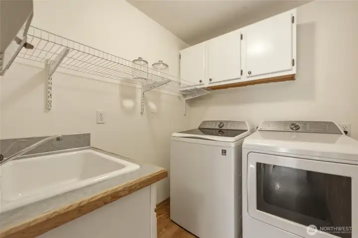 Wonderful laundry room with utility sink, shelf, and cabinet--it's a dedicated room so there is no need to "pass through" on your way to the garage--you can close the door if you like! :D
