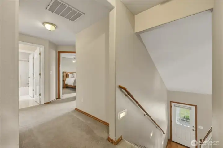 Stair lights guide you to the upper level (perfect at night or for ambient lighting!) to this open landing/hallway.