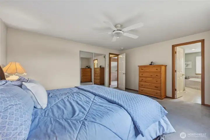 1st closet (with mirrored doors) seen here, as well as en suite bathroom with 2nd closet.