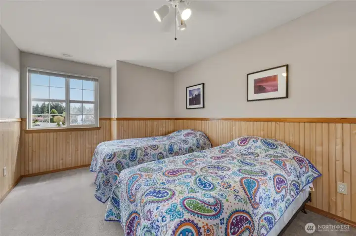 Bedroom #2 offers beadboard detail for a fun and stylish feel. Mirrored closet doors to right of photo.