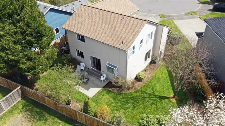Aerial view showing the yard space and beautiful trees/greenery.