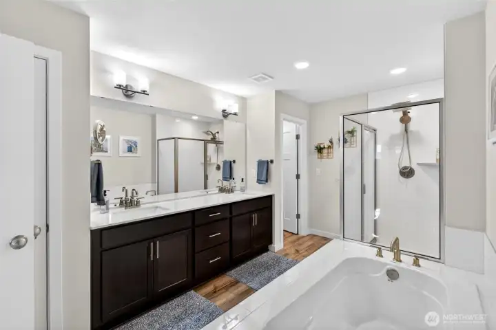 Dual vanities, built-in makeup station, soaking tub and separate shower