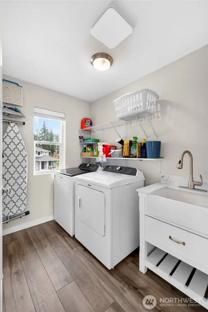 Upstairs laundry room with utility sink for added convenience