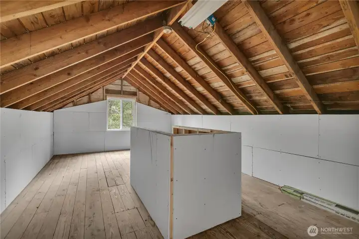 Unfinished bonus room area with potential for customization or additional storage