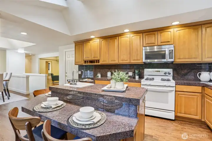 Gas cooking, granite counters, tons of storage space, and bar seats to watch the chef at work. Gas cooking, granite counters, tons of storage space, and bar seats to watch the chef at work.