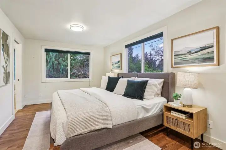 The primary bedroom is one of two bedrooms on the main level, with plenty of space and great natural light. The primary bedroom is one of two bedrooms on the main level, with plenty of space and great natural light.