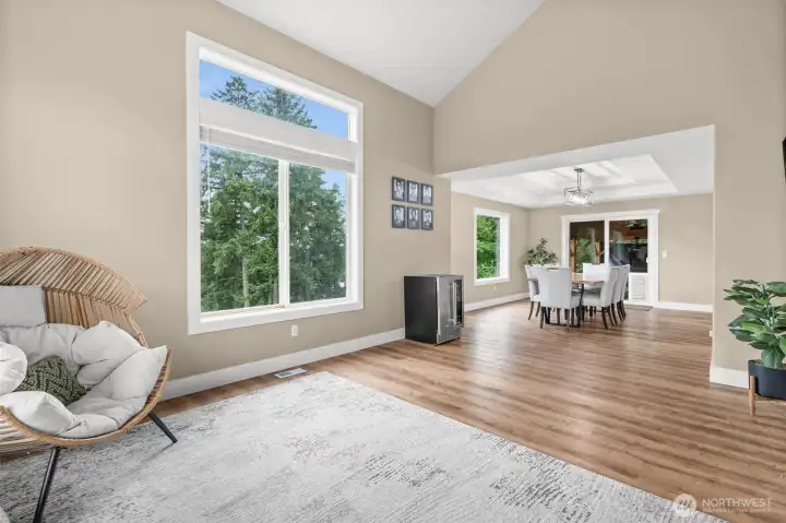 Oversized windows allow cascading natural light to fill the room with filtered natural illumination.