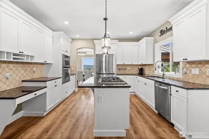 Tastefully remodeled kitchen with granite, SS appliances, white Shaker cabinets to give the perfect amount of contrast.