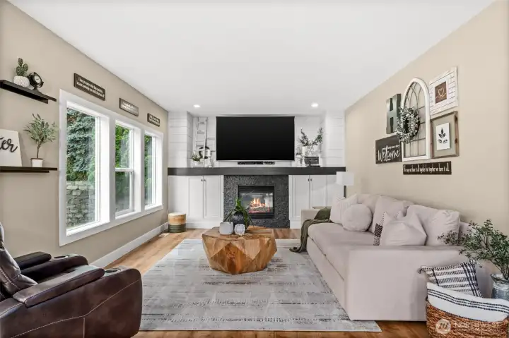 While in Gourmet kitchen one can watch 85 inch TV while preparing fresh cuisine. Not to mention farmhouse chic white barn-wood with granite stacked stone fireplace surround.The contrasting colors makes the beautiful wood mantle pop.