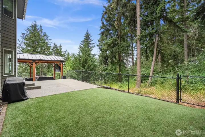 Fully-fenced, level backyard is a blank canvas with synthetic lawn for low maintenance and perfect look.