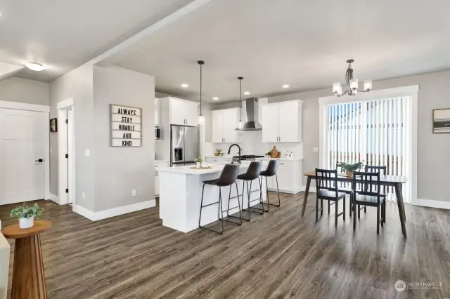 Great kitchen with quartz counters, stainless appliances, a giant walk-in-pantry, and an island with eating bar.