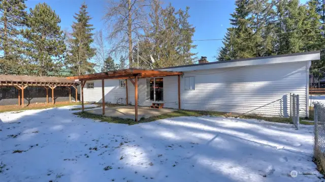 Step outside to the covered back patio overlooking the large backyard.