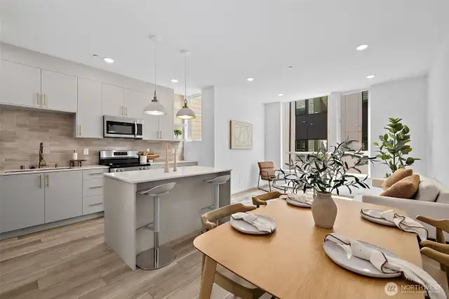 Great room with kitchen island! Model home. Colors and finishes may vary.