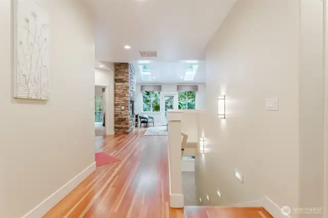 View from your entry looking into the living room and down towards the lower level