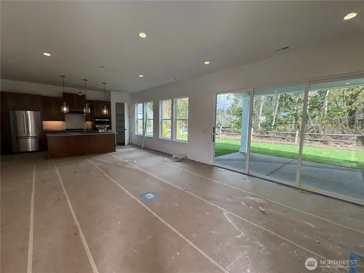 Kitchen and Great room with lots of windows and slider to covered patio.