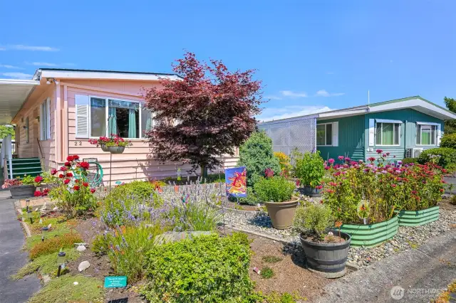 Welcome to Unit #22 in Park Village, a wonderful 55+ community park with premium landscaping.