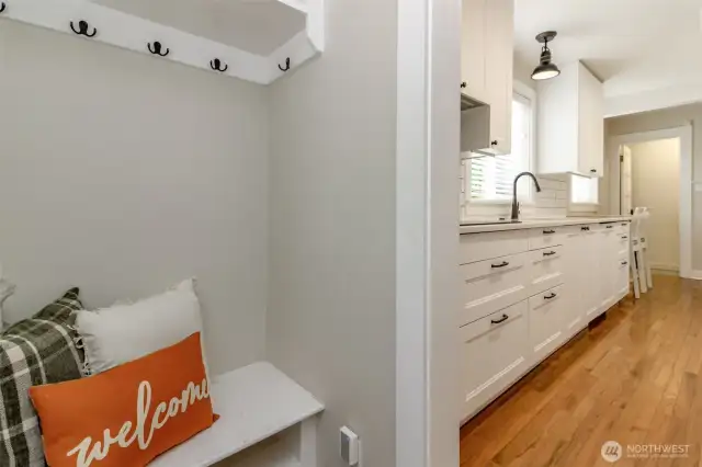 Cute bench, coat, shoes and backpack storage on the porch that leads from the back covered patio!