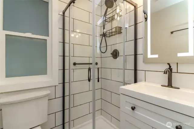 Primary bathroom with lighted mirror and modern touches!