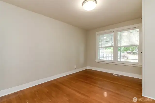 Primary bedroom with beautiful hardwood floors and flooded with natural light.