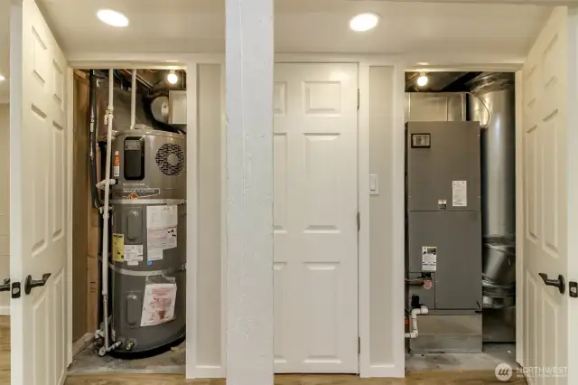 New hot water tank in one closet, storage in the other and forced air furnace is in the third. There is a heat pump for heating and air conditioning.