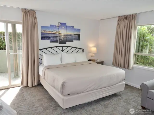 Main Bedroom w/ king-sized bed and lots of natural light.