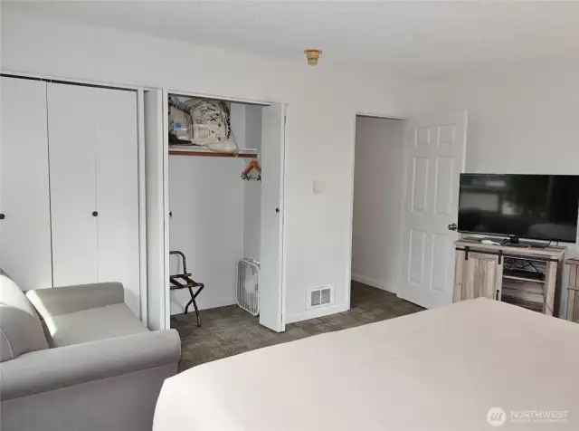 Main Bedroom w/ small loveseat.