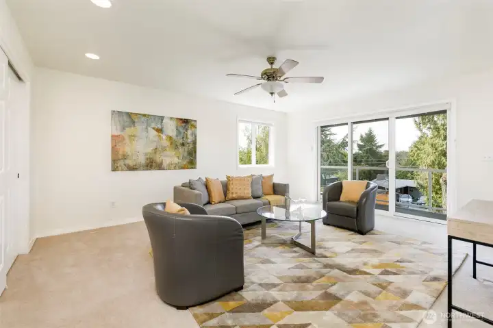 Upper level third bedroom or family room features balcony.