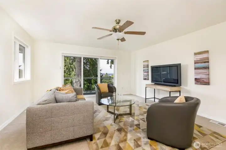 Upper level third bedroom or family room features balcony.