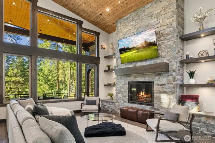 Great room anchored by a stunning stone fireplace.