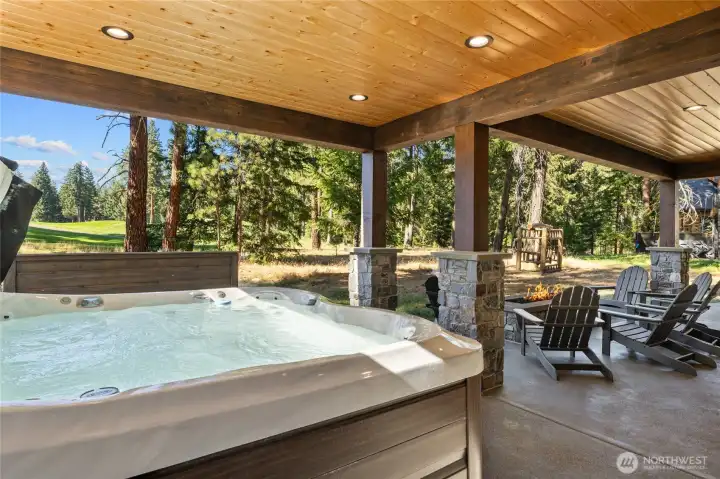 Covered outdoor living blends comfort and style. Private spa for relaxation after a round of golf.