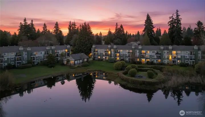 twilight drone shot of condos from across the lake