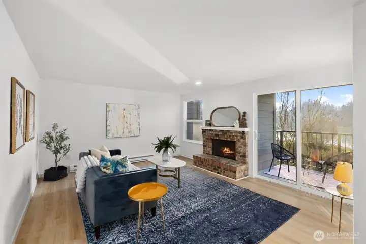 Living room w/ new LVP flooring throughout, wood burning fireplace