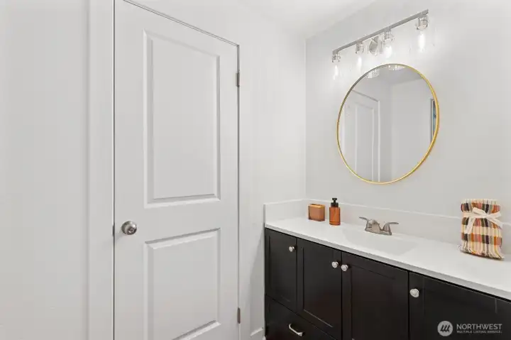primary ensuite full bathroom with new mirror, lighting sconce, new vanity and sink hardware