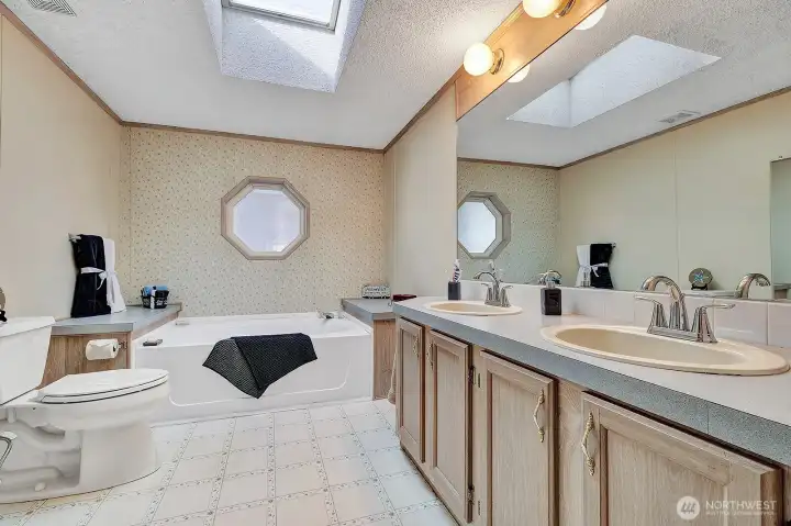 Generous sized 5-piece bath off the primary is the perfect place to relax and unwind from the day in the new soaking tub. Double sinks with storage in vanity below.  A separate step in shower for your convenience. Linen closet for towels and all your bathing necessities. Wheelchair or walker accessible.