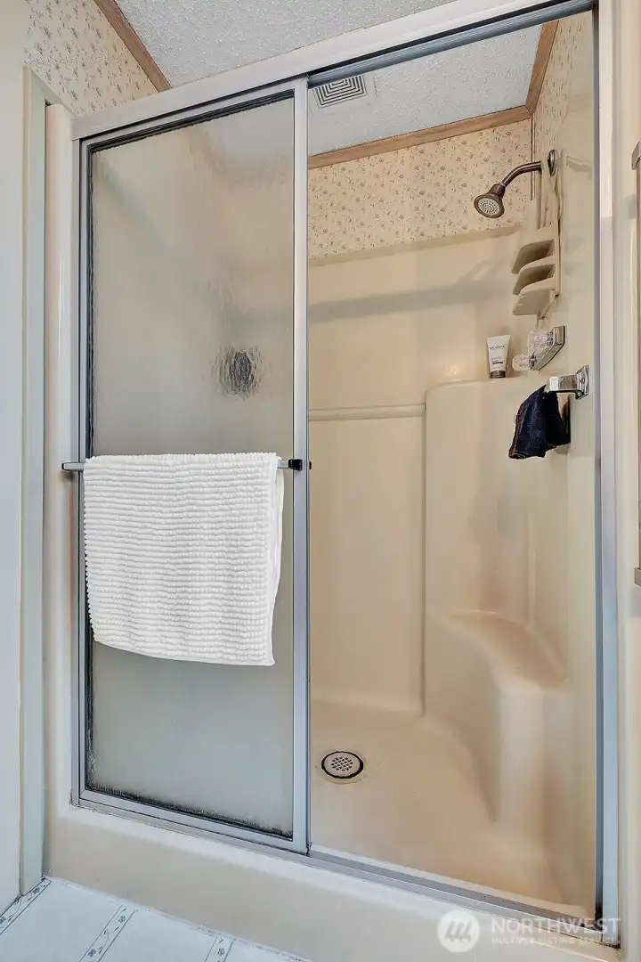 Seated, step in shower in the primary bathroom for your convenience.
