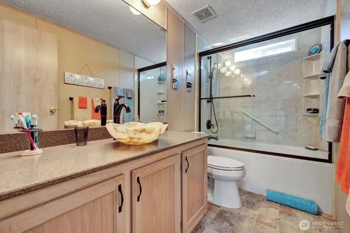 Full guest bath off the family room area. Updated and like new! Handrails for your safety. Designer accents include tile surround and more.