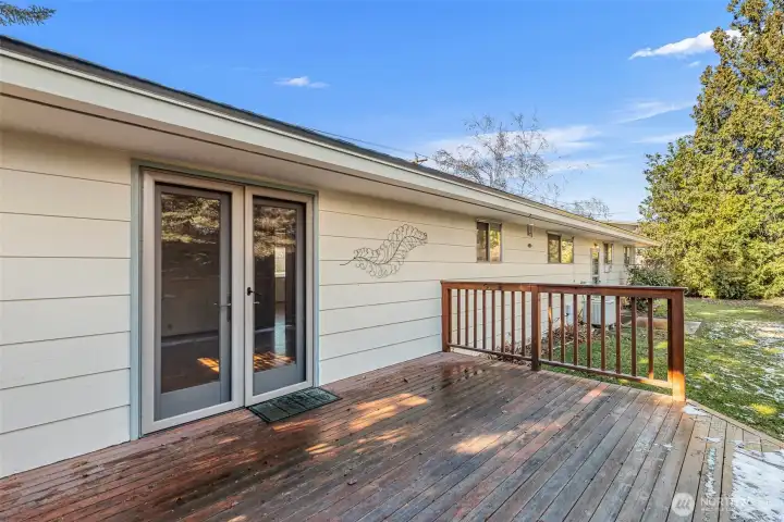 Quality french door leads to shady deck in the summertime